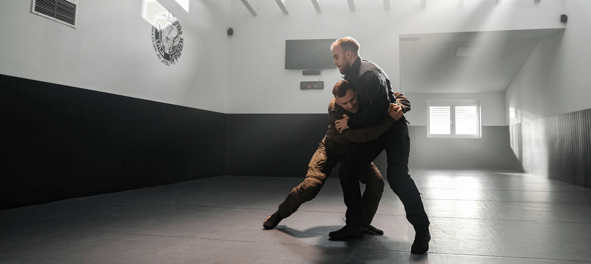 Front body lock position demonstration in Brazilian Jiu Jitsu.